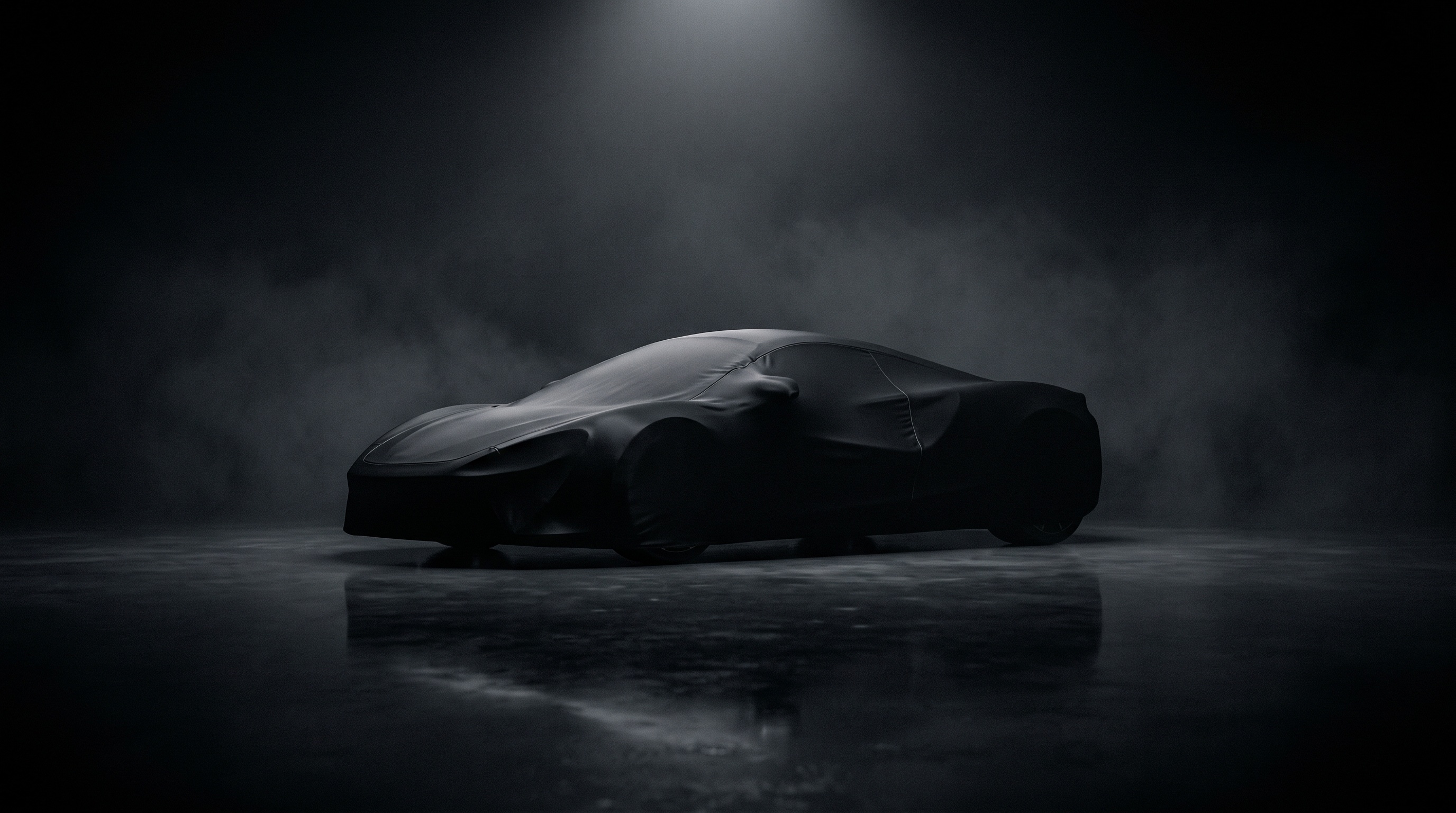 A covered supercar silhouette under a dim spotlight